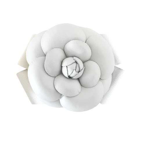 White camellia flower brooch on white background