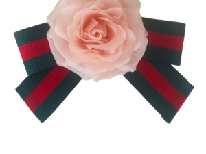 Pink fabric rose on green and red ribbon