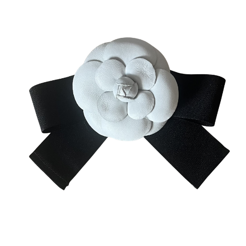 White camellia brooch with black ribbon bow