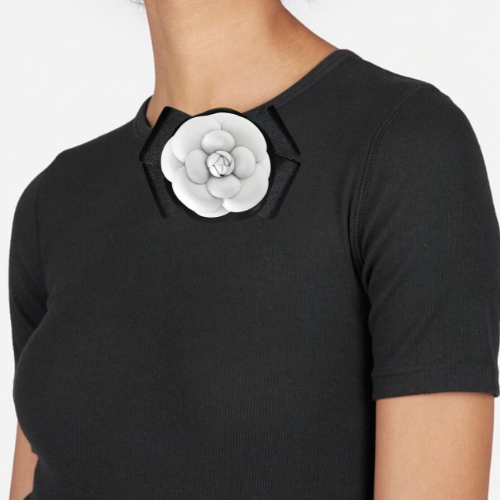 White flower brooch on black shirt